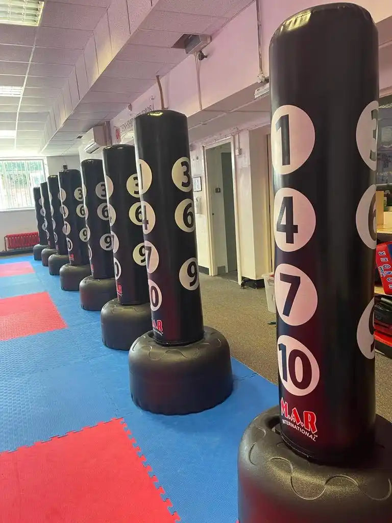 Black punching bags with numbered targets.