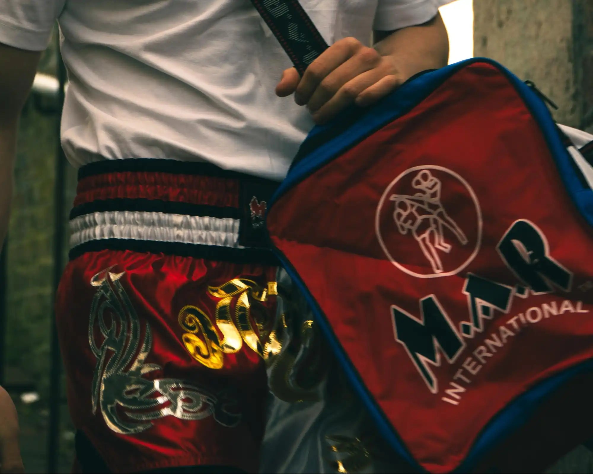 Muay Thai fighter with gym bag.
