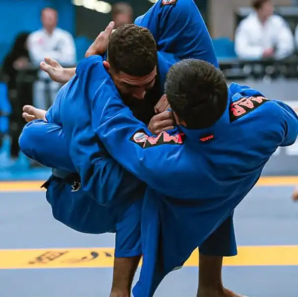 Two blue-clad grapplers.