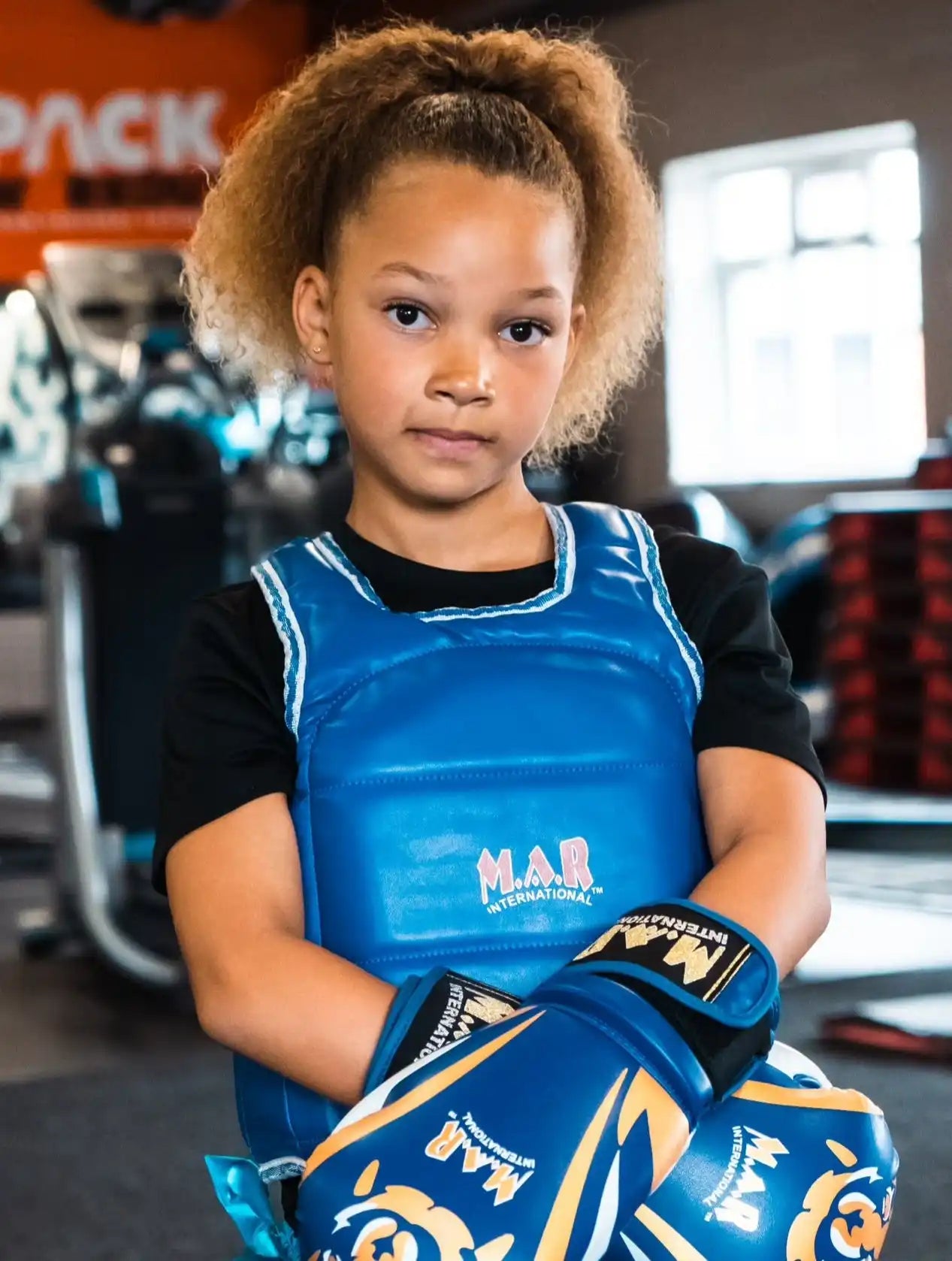 Young boxer with blue protective gear.